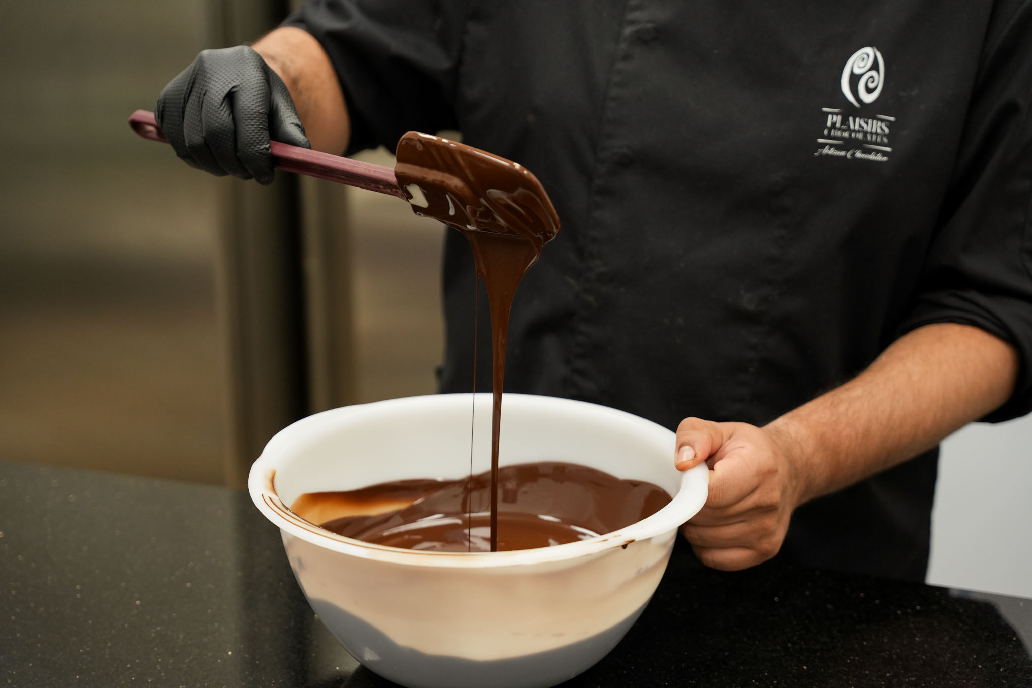 Artisan chocolatier préparant du chocolat artisanal à Bruxelles
Fabrication artisanale de pralines belges
Tempérage du chocolat dans notre atelier à Bruxelles
Chocolat fondu préparé selon un savoir-faire artisanal
Confection artisanale de chocolats belges
Enrobage manuel de pralines en chocolat
Création de chocolats artisanaux dans notre atelier
Chocolatier façonnant des pralines à la main
Atelier de fabrication de chocolat artisanal belge
Préparation de ganache pour pralines artisanales
Moulage de chocolats artisanaux
Décoration de chocolats réalisée à la main
Travail du chocolat par un artisan chocolatier
Fabrication de tablettes de chocolat belge
Préparation de recettes artisanales au chocolat